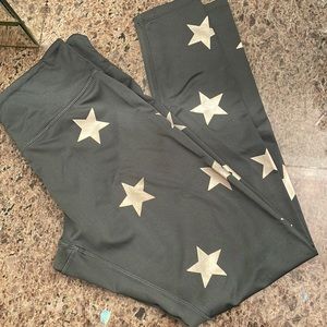 Used- JessicaSimpson leggings. Deep green with gold matt star print. Size M